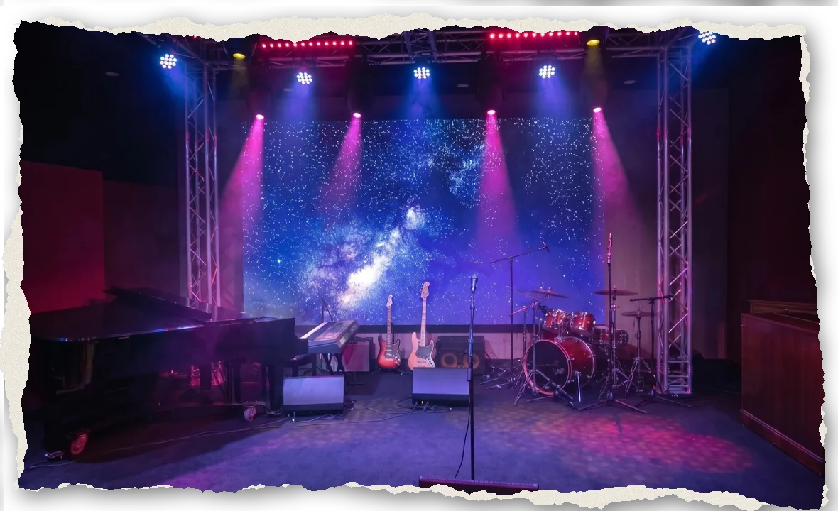 The Live Room at The Recording Club with its starfield LED wall, pink stage beams, piano, guitars and drums